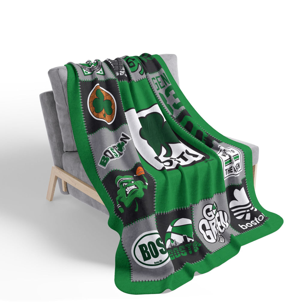 Green Boston basketball patchwork-style fleece blanket draped over a gray chair