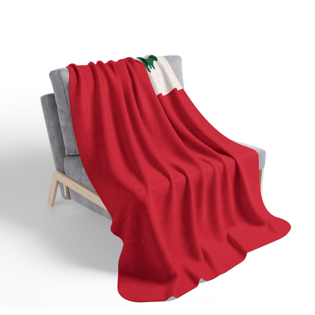 Red Vintage New England Flag fleece sherpa blanket draped over a gray chair