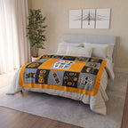 Gold, black and gray Boston hockey fleece blanket displayed across a bed