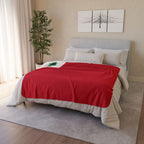 Vintage New England Flag fleece sherpa blanket displayed across a bed with its red field and green pine tree visible