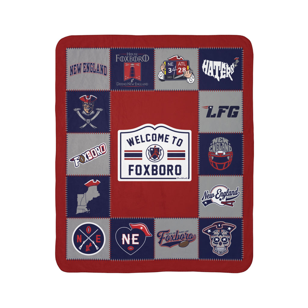 New England football fleece sherpa blanket laid flat with red, navy and gray graphics around a Welcome to Foxboro sign