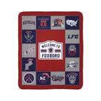 New England football fleece sherpa blanket laid flat with red, navy and gray graphics around a Welcome to Foxboro sign