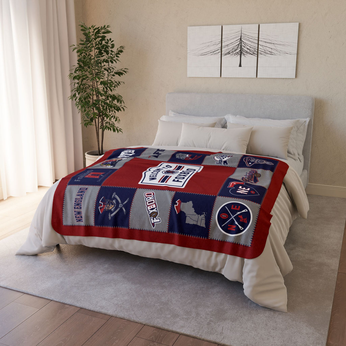 Red, navy and gray New England football fleece blanket displayed across a bed