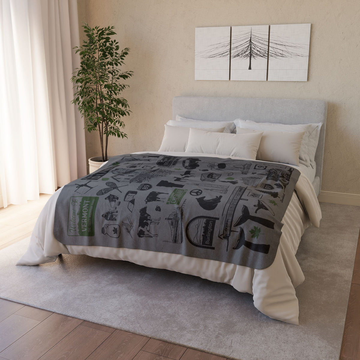 Vermont tourist-attraction fleece blanket spread across a bed in a neutral bedroom