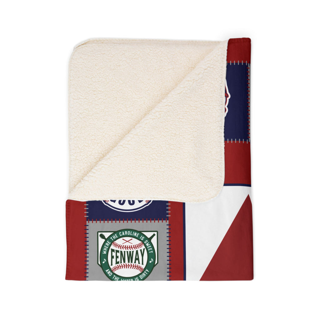 Folded corner of Boston baseball blanket showing cream sherpa underside and Fenway print