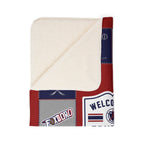 Folded New England football blanket showing cream sherpa underside and Foxboro patchwork-style print