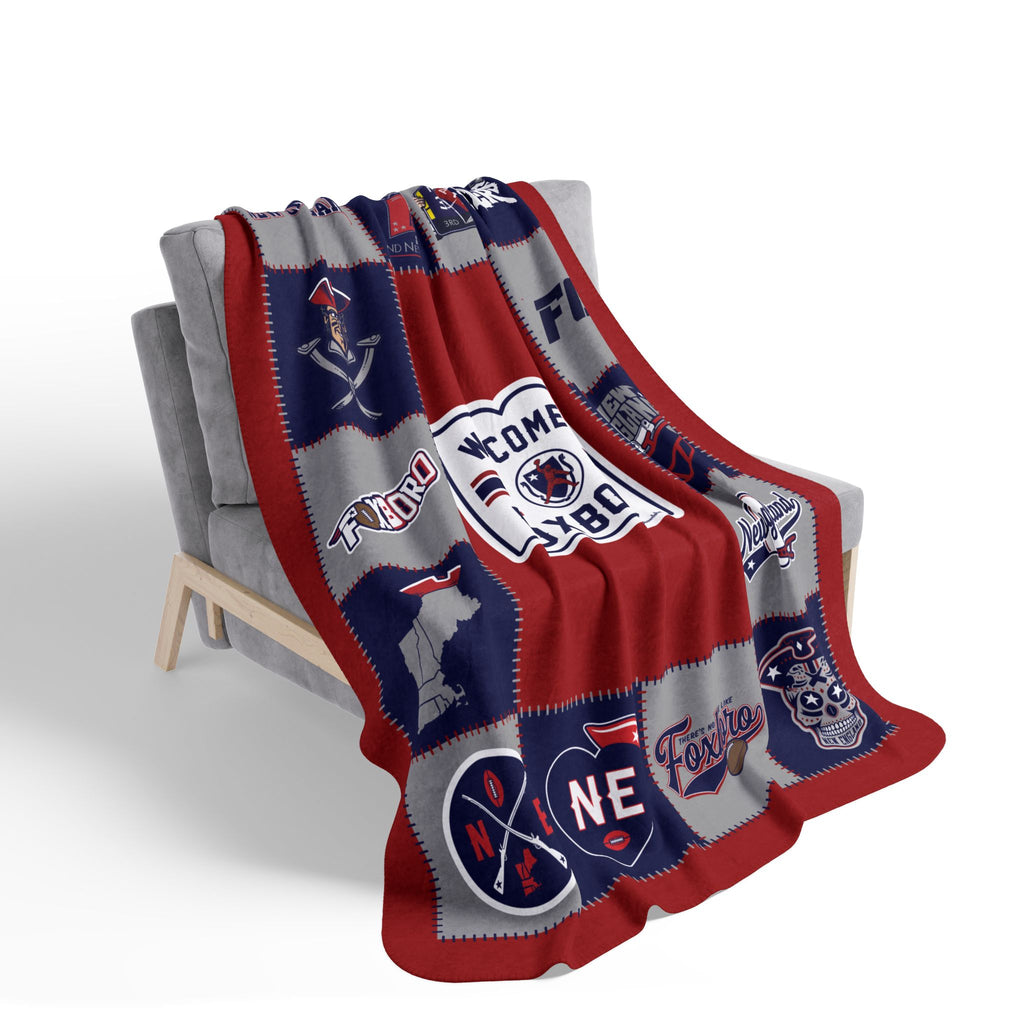 New England football Foxboro patchwork-style fleece blanket draped over a gray chair