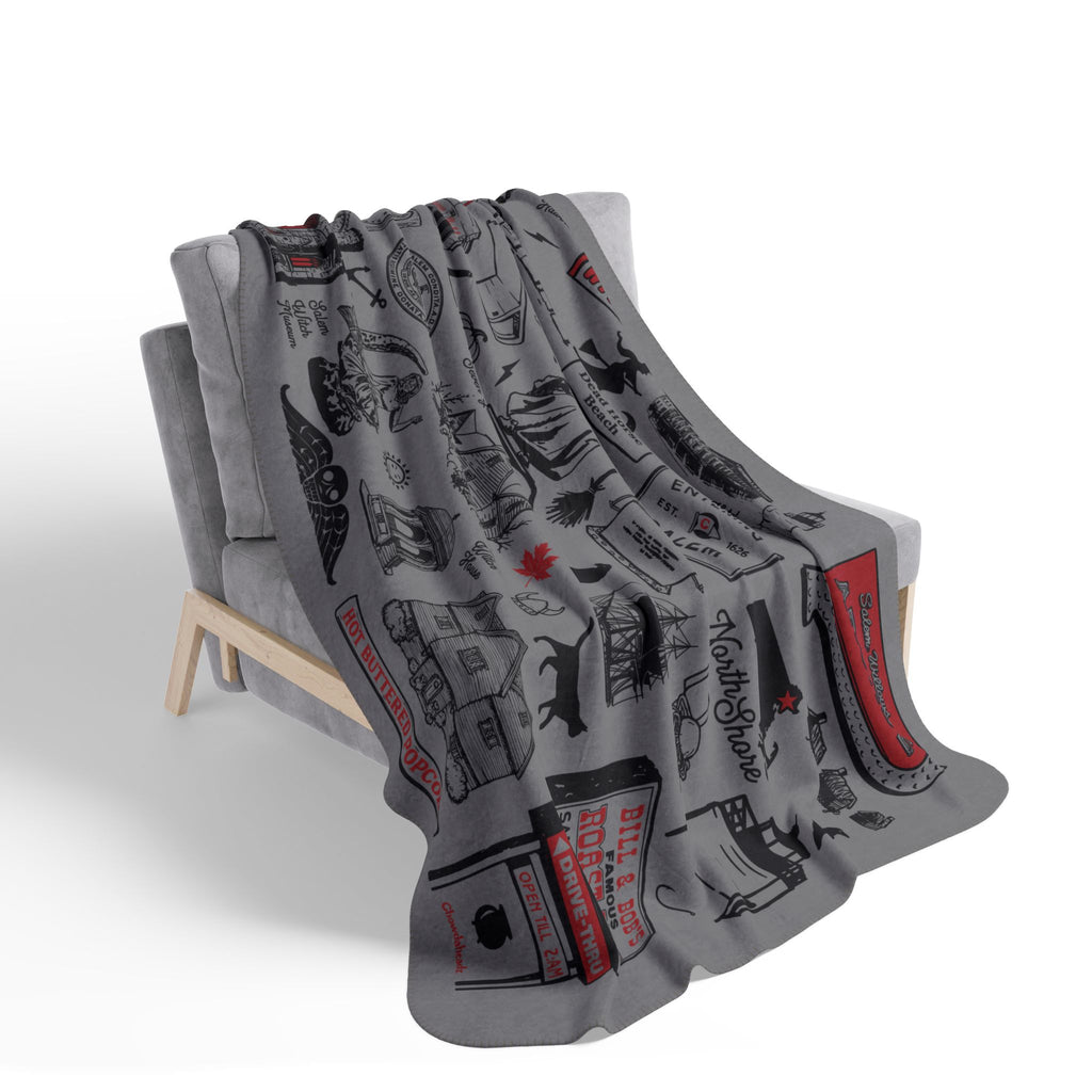 Gray Salem tourist-attraction blanket with black and red illustrations draped over a chair