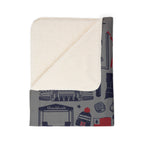 Folded Foxboro football blanket showing cream sherpa underside and gray illustrated fleece front
