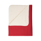 Folded corner of red New England flag blanket showing the cream-colored sherpa underside