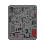 Salem fleece sherpa blanket laid flat with black landmark and witch illustrations and red accents on gray