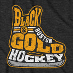 Close-up of distressed gold and white Black & Gold Boston Hockey skate artwork