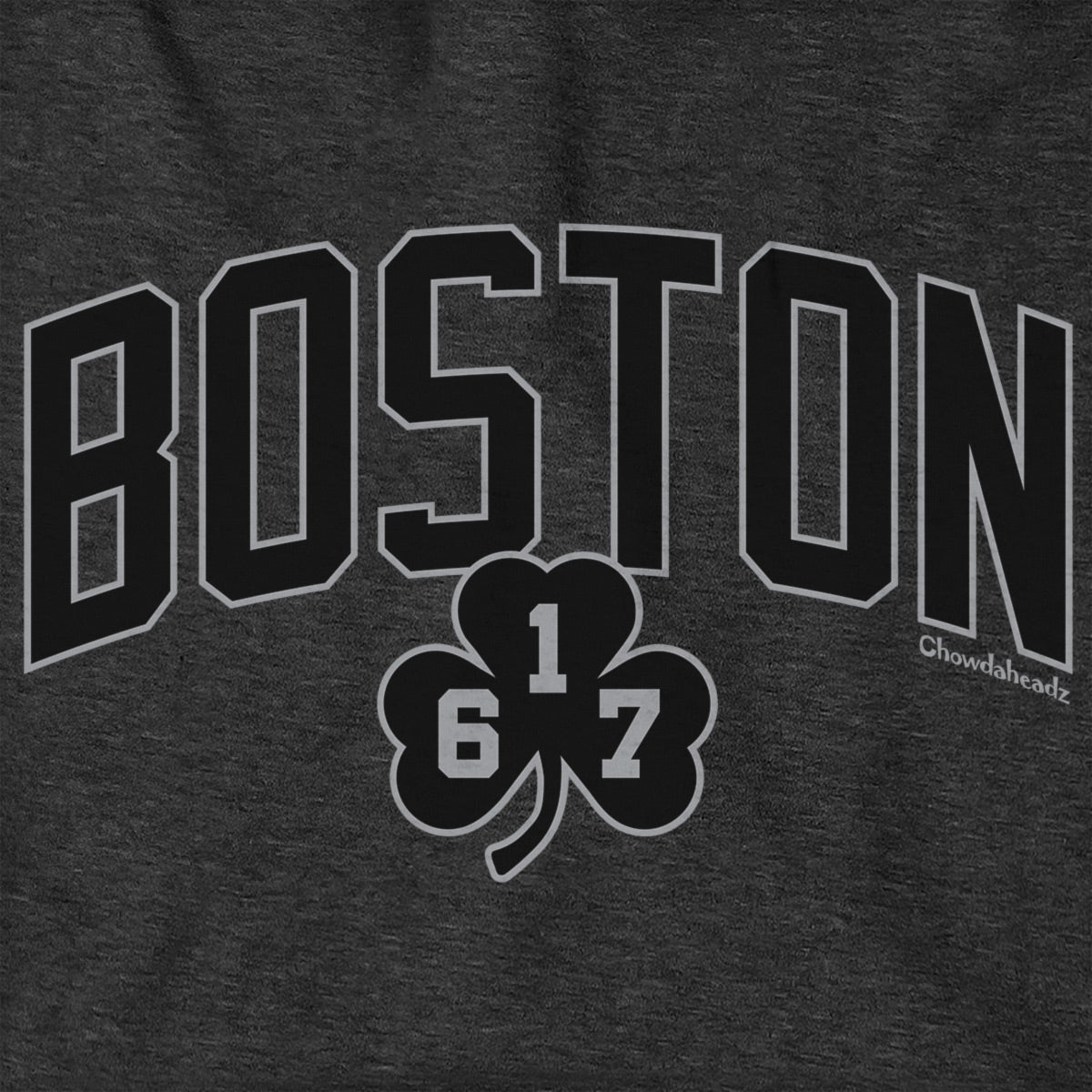 Close-up of black BOSTON lettering and a 617 shamrock outlined in gray on charcoal fabric