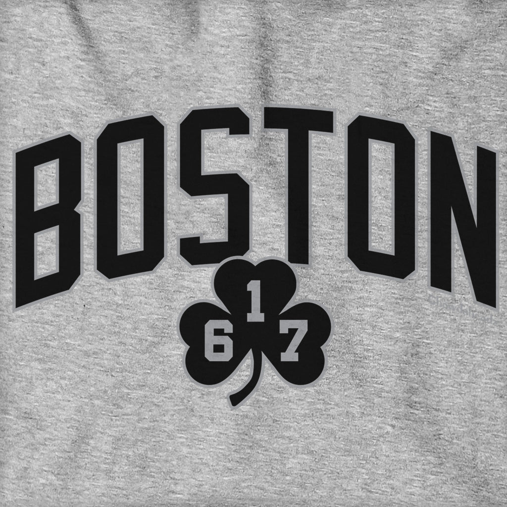 Close-up of black BOSTON arch lettering and 617 shamrock on gray fabric