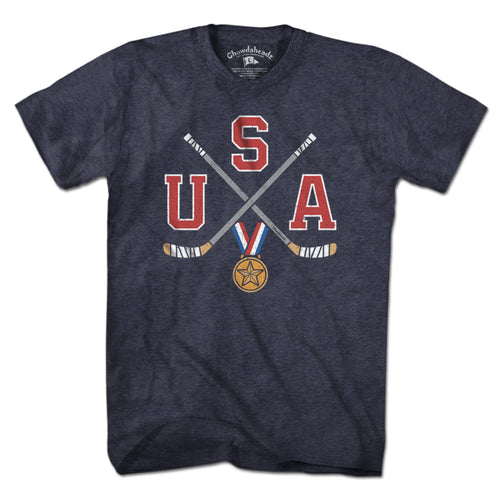 USA Cross Sticks Hockey t-shirt in heather blue — crossed hockey sticks on stars-and-stripes graphic