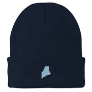 Front view of a navy cuffed knit hat with a small light-blue Maine-shaped patch outlined in dark thread