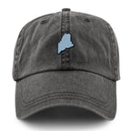 Straight-on front view of a washed charcoal dad hat with a light-blue Maine-shaped patch outlined in dark thread