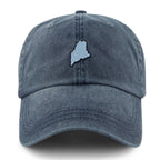 Straight-on front view of a washed navy dad hat with a light-blue Maine-shaped patch outlined in dark thread