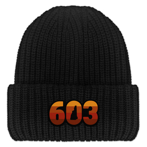 Front view of a black Retro 603 New Hampshire chunky knit winter hat with orange-and-red-striped numbers and a state silhouette in the zero