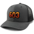 Three-quarter front view of a charcoal Retro 603 New Hampshire snapback trucker hat with orange-and-red-striped numbers and a state silhouette in the zero