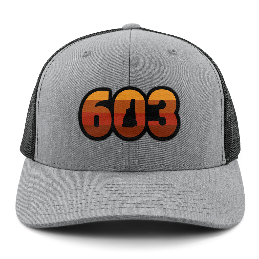 Front view of a gray Retro 603 New Hampshire snapback trucker hat with orange-and-red-striped numbers and a state silhouette in the zero