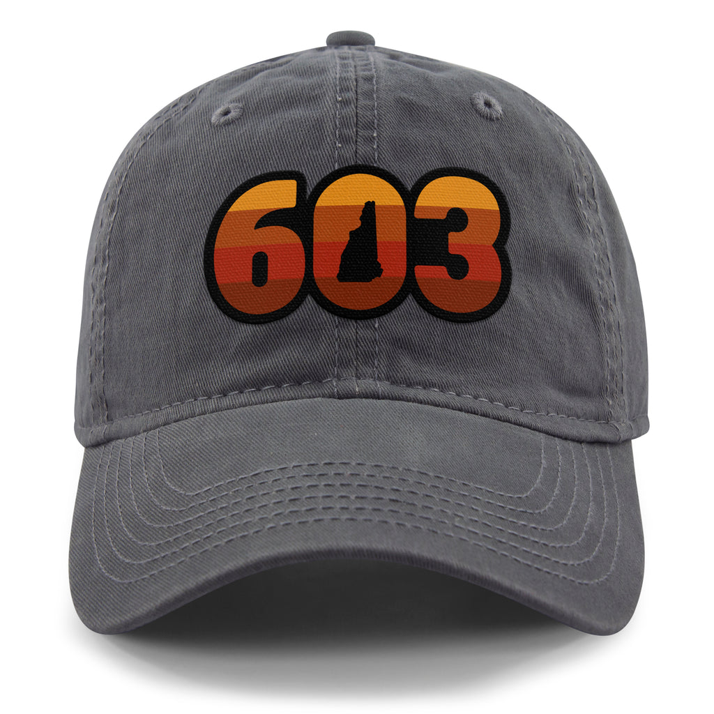 Front view of a charcoal Retro 603 New Hampshire dad hat with orange-and-red-striped numbers and a state silhouette in the zero