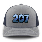 Front view of a navy/gray Retro 207 Maine snapback trucker hat with blue-striped numbers and a state silhouette in the zero