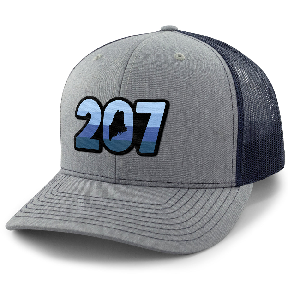 Three-quarter front view of a navy/gray Retro 207 Maine snapback trucker hat with blue-striped numbers and a state silhouette in the zero