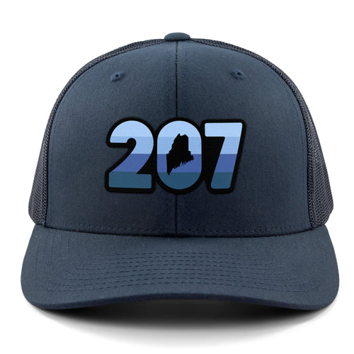 Front view of a navy Retro 207 Maine snapback trucker hat with blue-striped numbers and a state silhouette in the zero