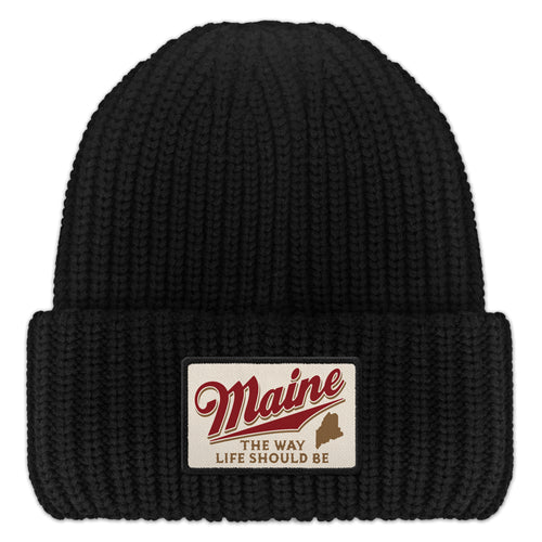 Front of black chunky knit hat with folded cuff and Maine The Way Life Should Be patch
