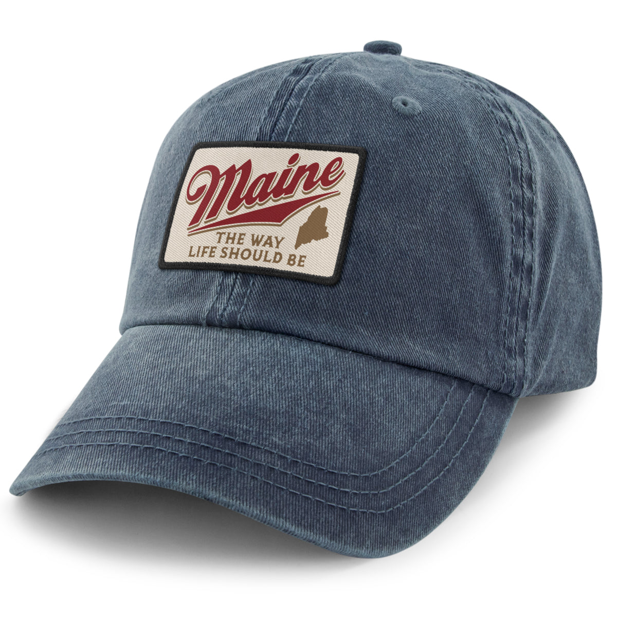 Angled front view of navy washed dad hat with cream Maine patch, red script and state silhouette