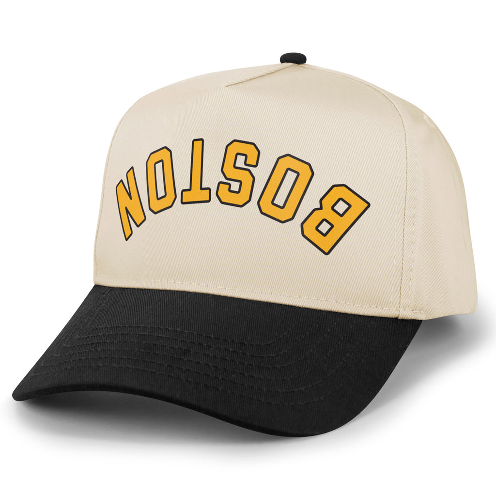 Black and stone Boston hockey retro snapback hat with upside-down gold BOSTON lettering, angled front view