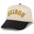 Black and stone Boston hockey retro snapback hat with upside-down gold BOSTON lettering, angled front view