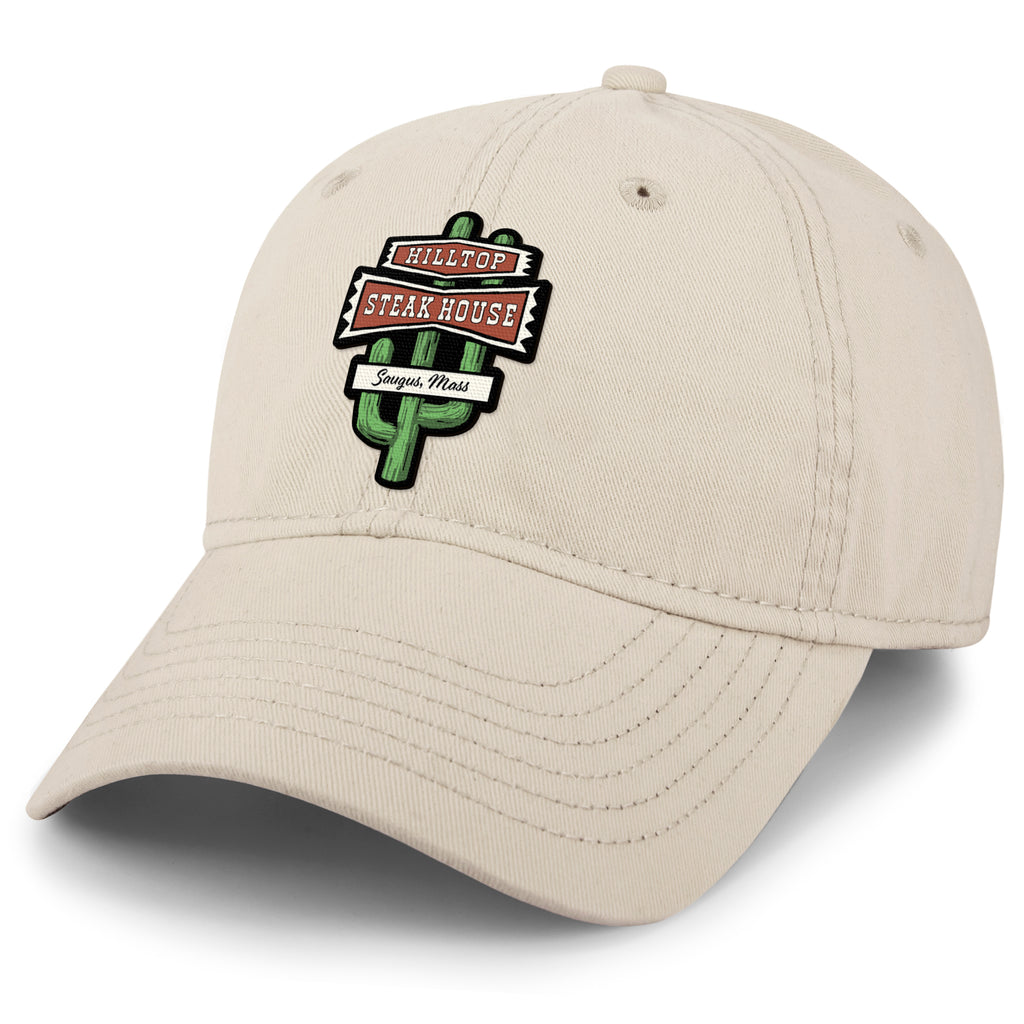 Angled view of stone Hilltop Steakhouse dad hat with green cactus sign and Saugus, Mass lettering