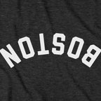 Close-up of Upside Down Arch t-shirt design in charcoal — inverted Boston arch detail