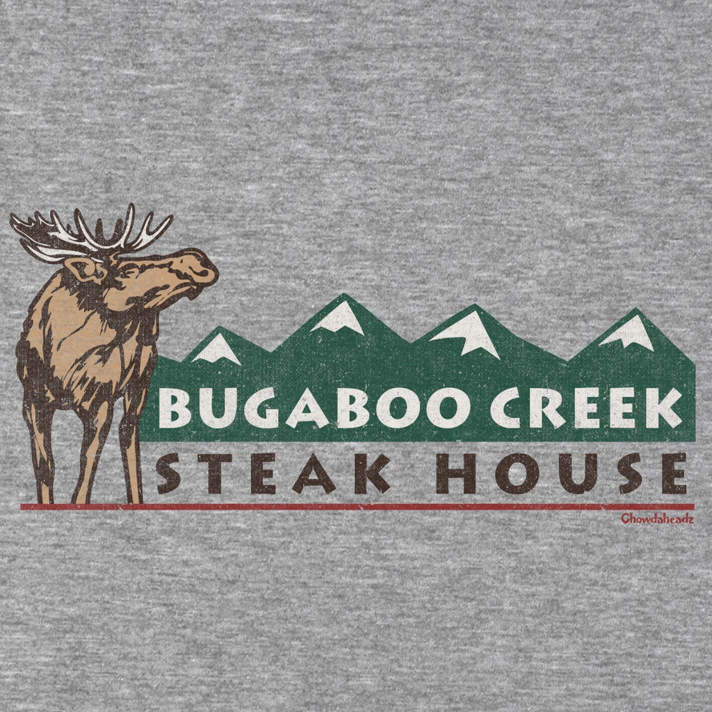 Close-up of the moose, green mountain peaks, and Bugaboo Creek Steak House lettering on gray fabric